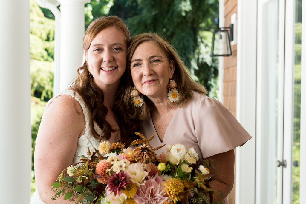 The bride and her mom with custom floral earrings