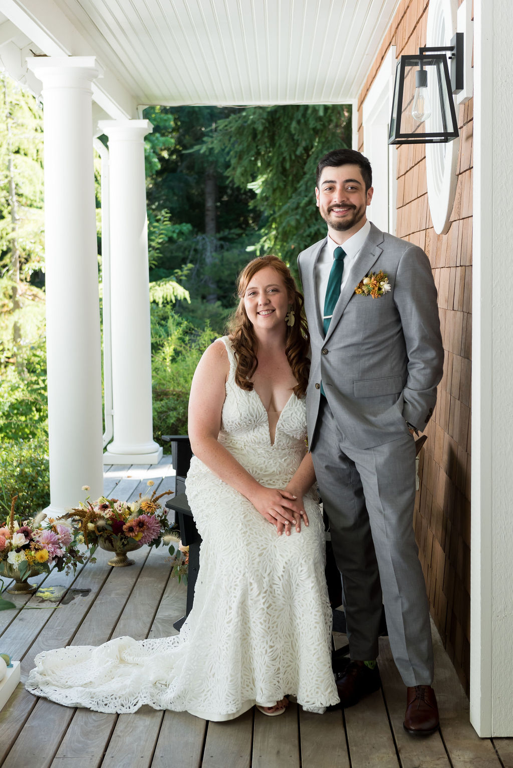 Bride and groom standing on porch