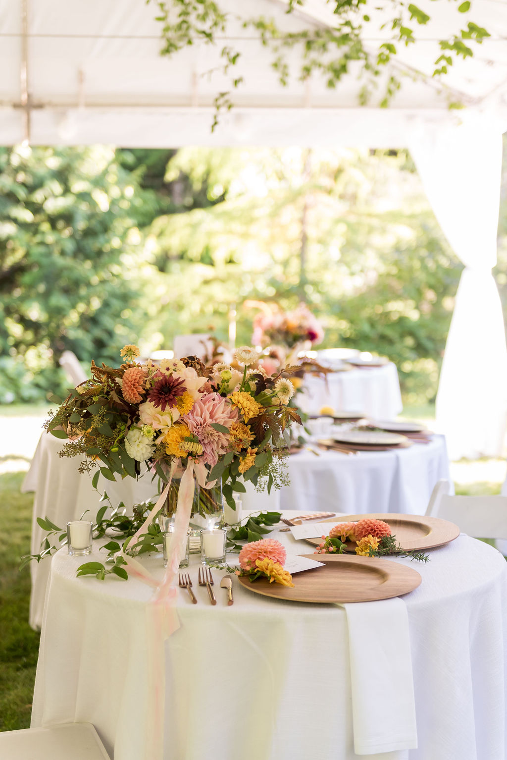 Tented wedding reception with florals on table