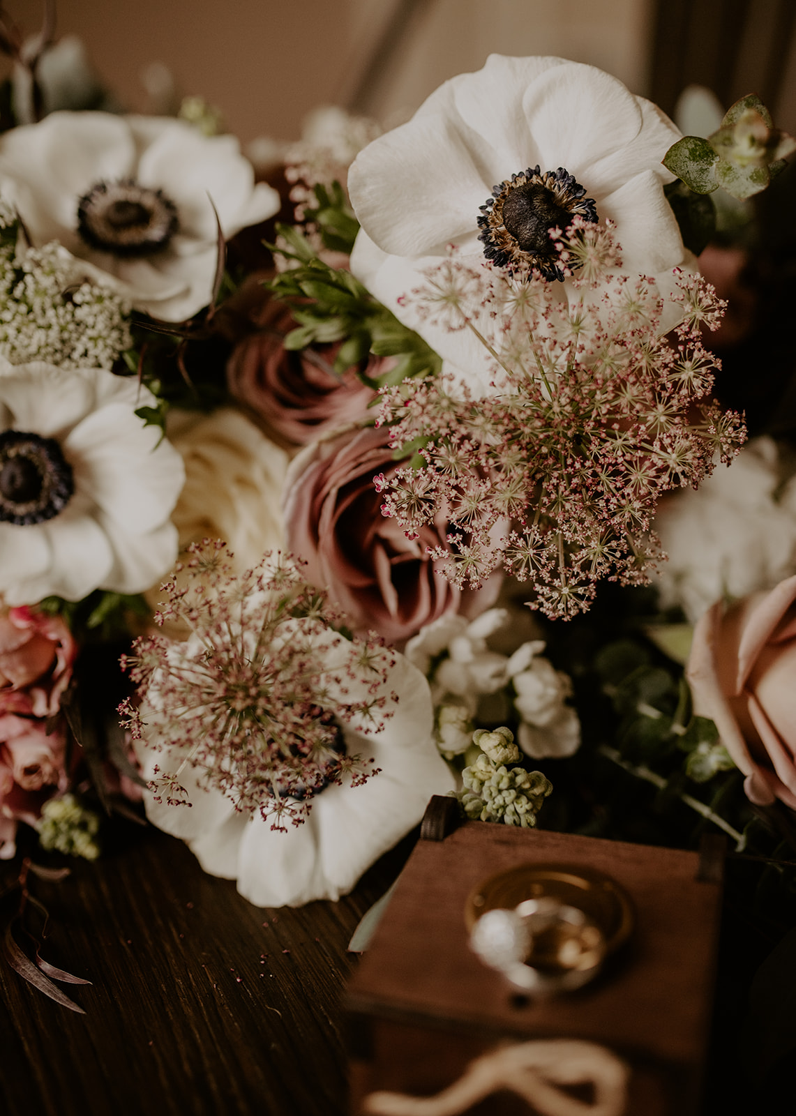 Wedding ring details with flowers in background