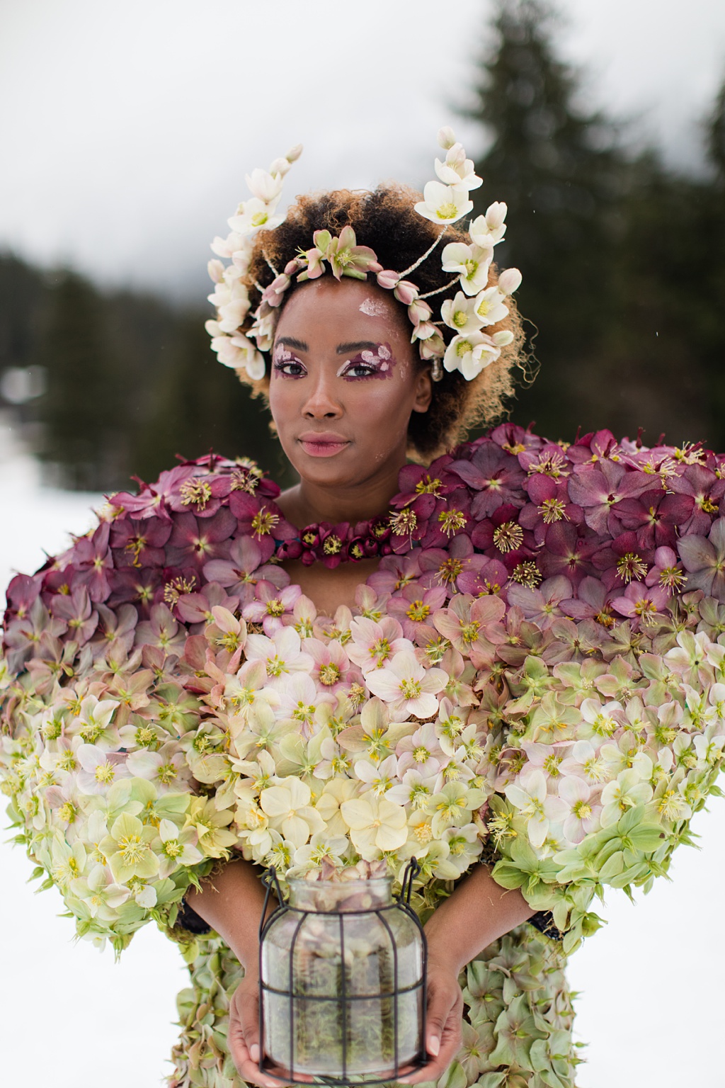 A bespoke flower dress made of hellebores, with model holding lantern