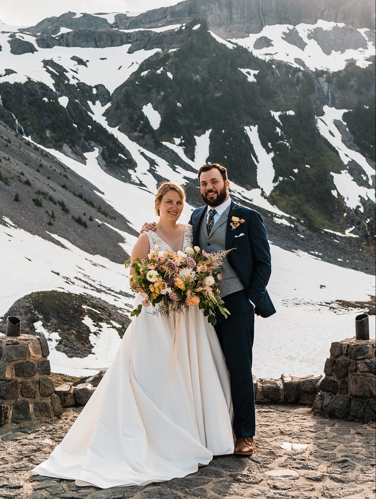 a couple standing in front of a mountain destination wedding