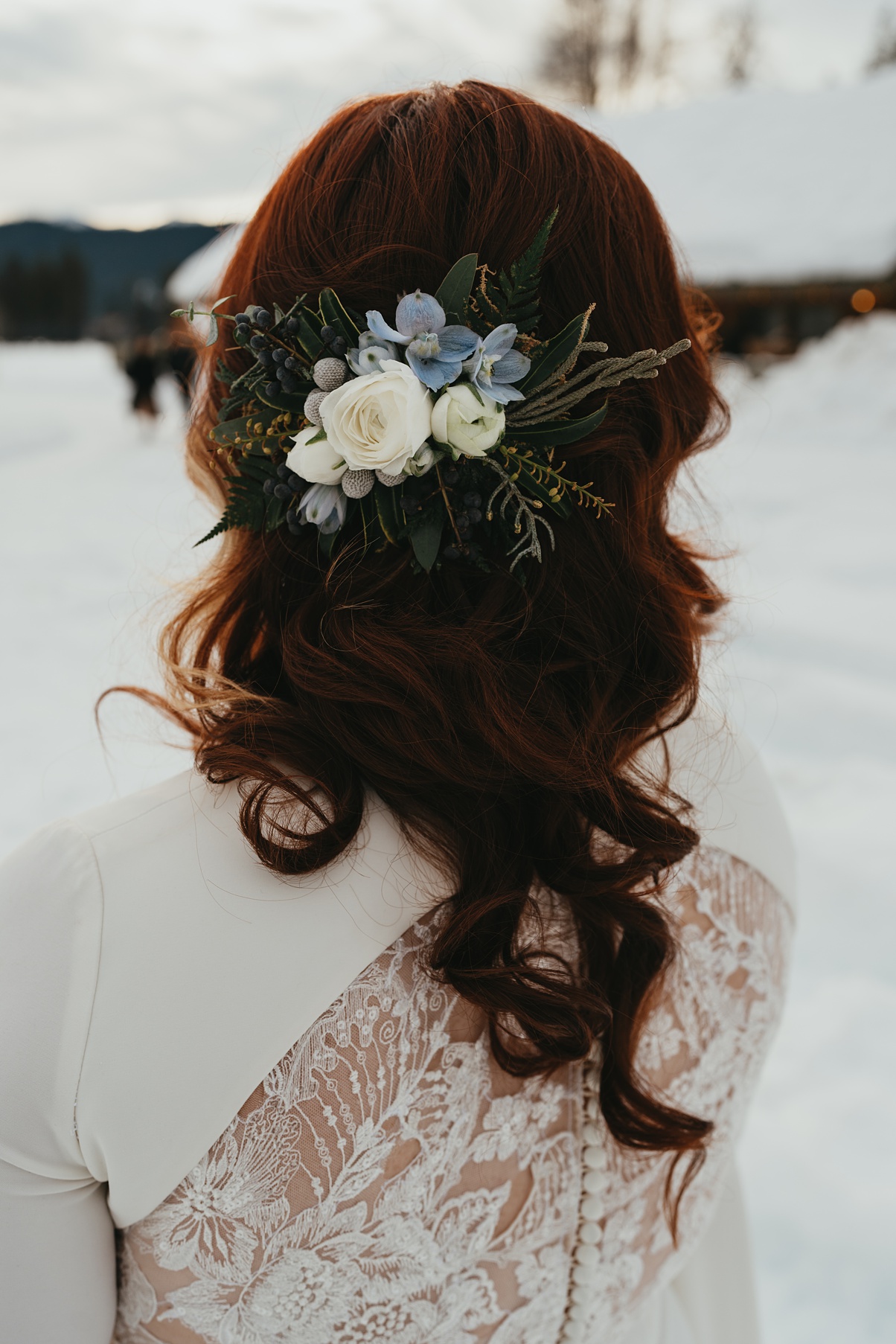 A bride with red hair and gorgeous flowers in her hair