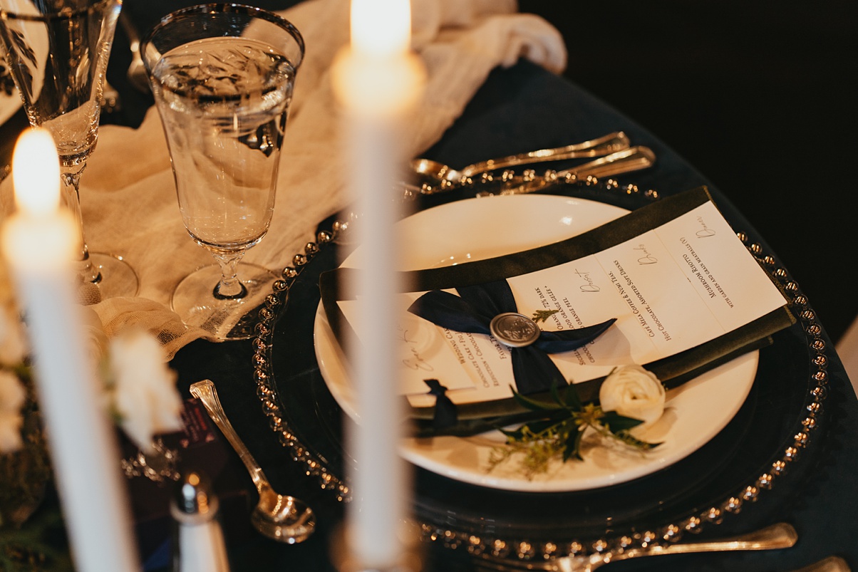 Sweetheart table details like candles, menus, and wax seals for this romantic wedding reception
