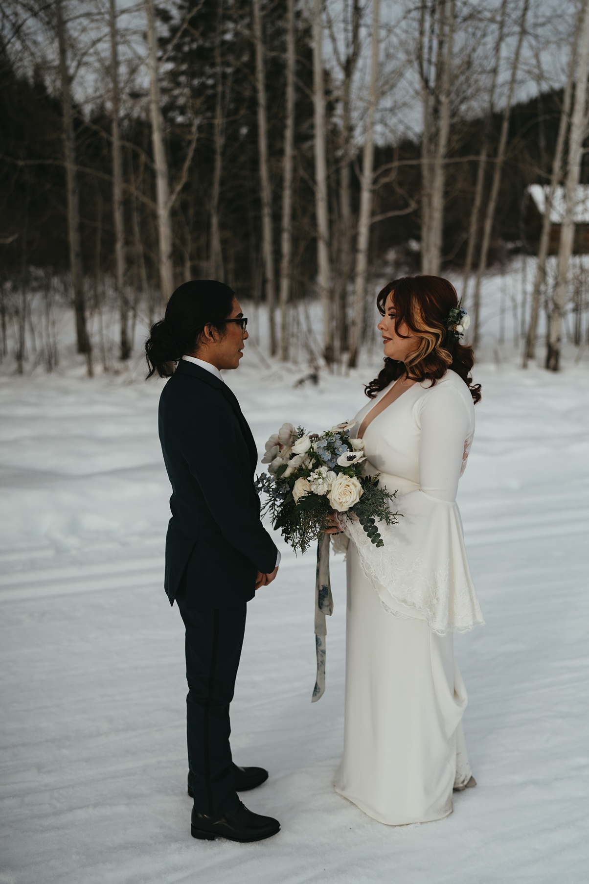 The couple having a snowy first look