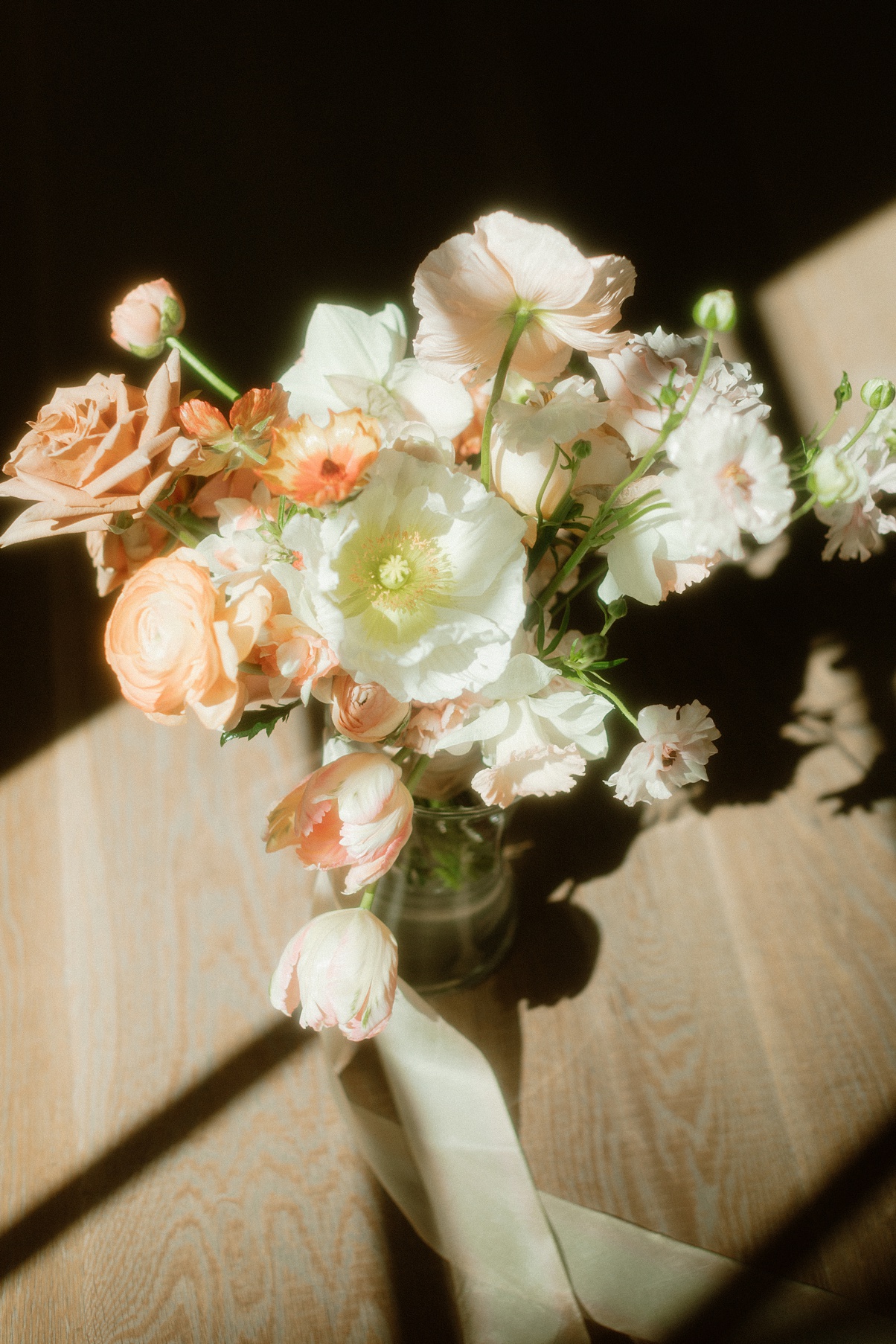 A delicate spring bouquet sits on the floor in the sun at a Block 41 wedding