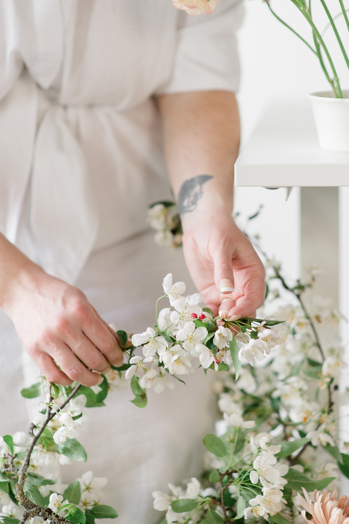 Seattle wedding florist Carolyn Kulb, owner of Bloom Poet, handling crabapple branches