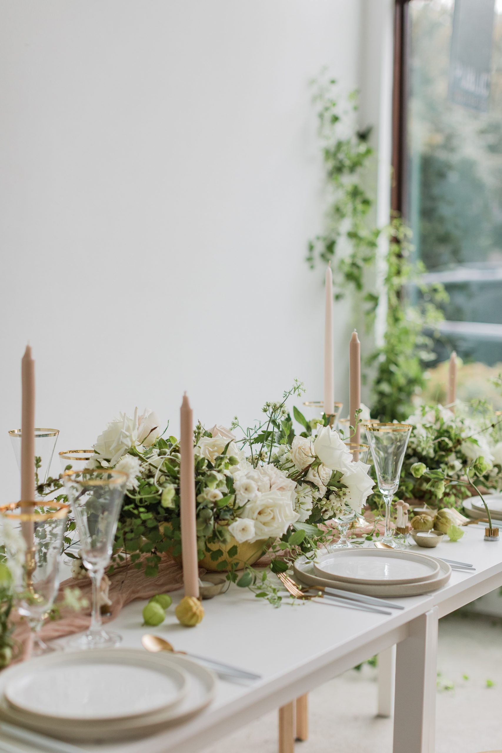 A white wedding table setup with window in the background