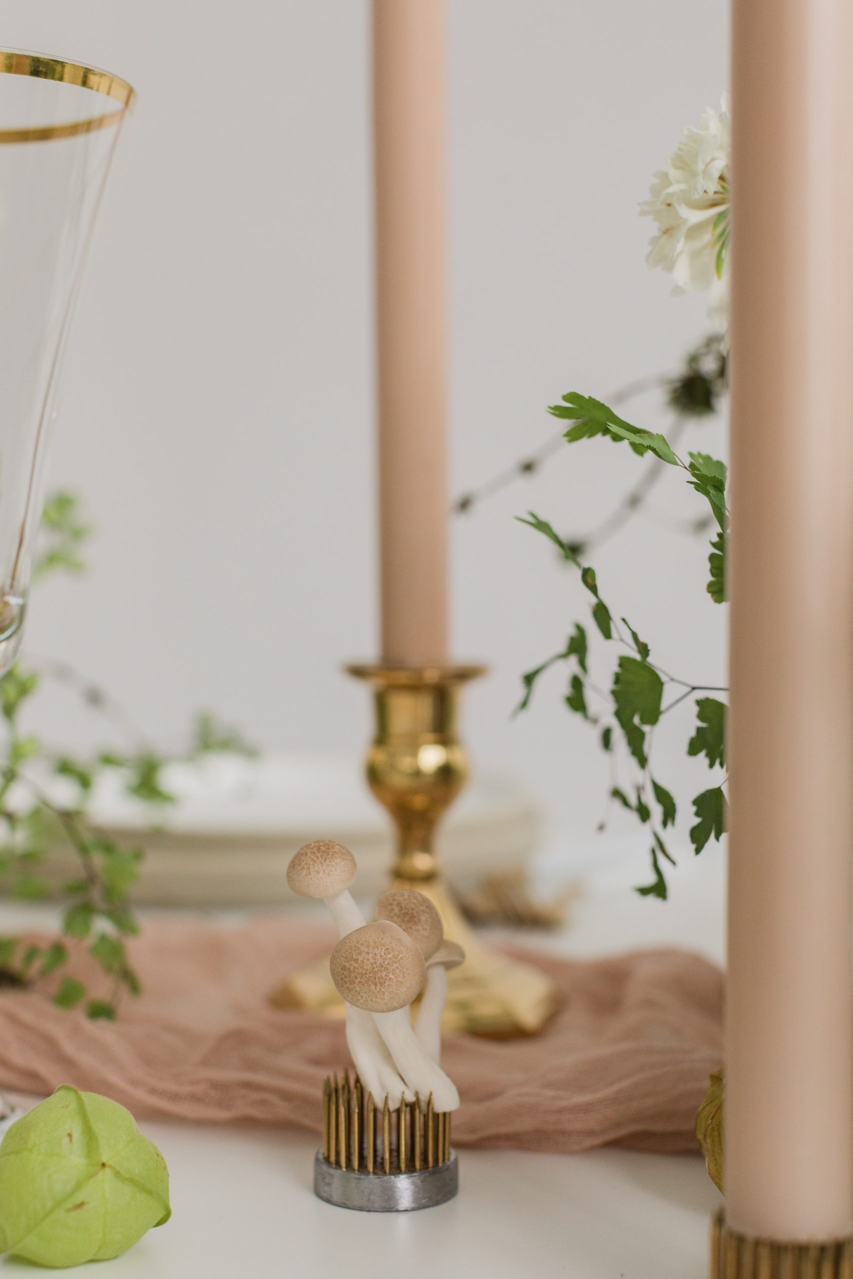 Tiny mushrooms add to the tablescape for this white wedding