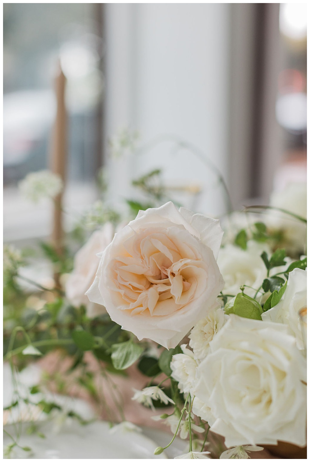 Blush and white garden roses in a May wedding arrangement