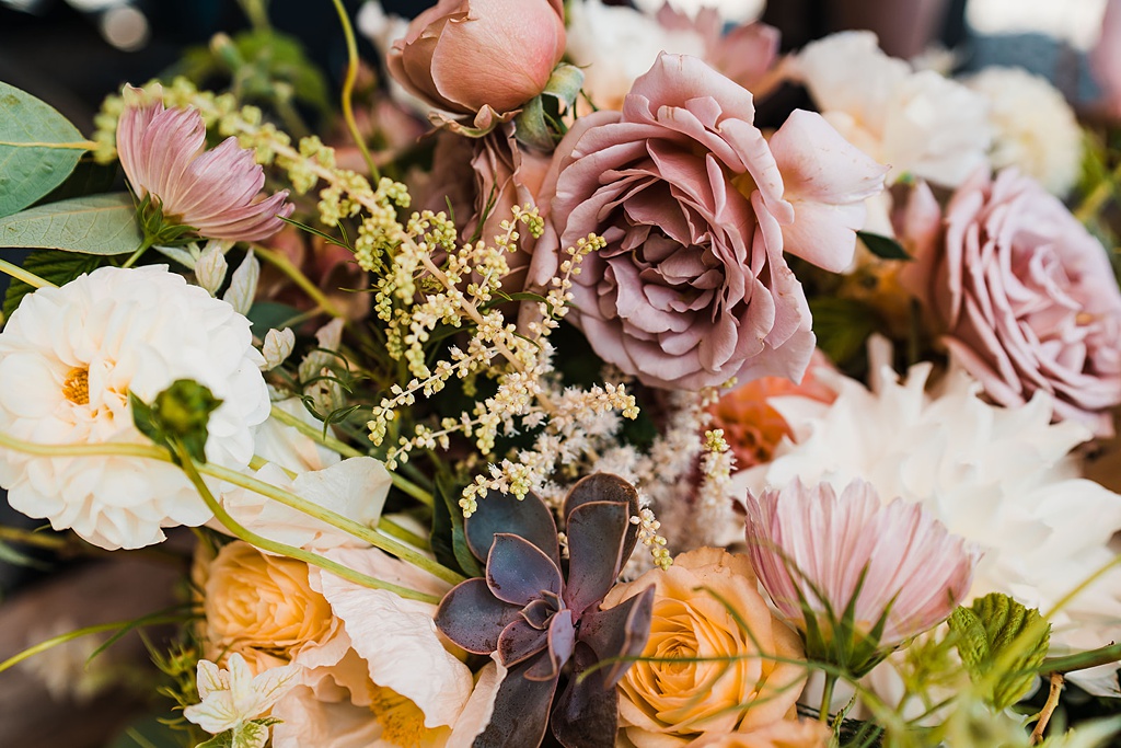 A July wedding bouquet with garden roses, cosmos, and astilbe