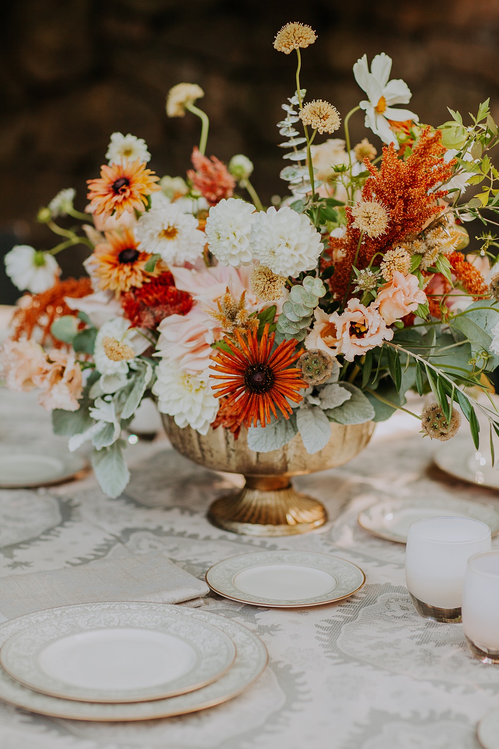 A wedding centerpiece highlighting most of our favorite August wedding flowers, including lisianthius