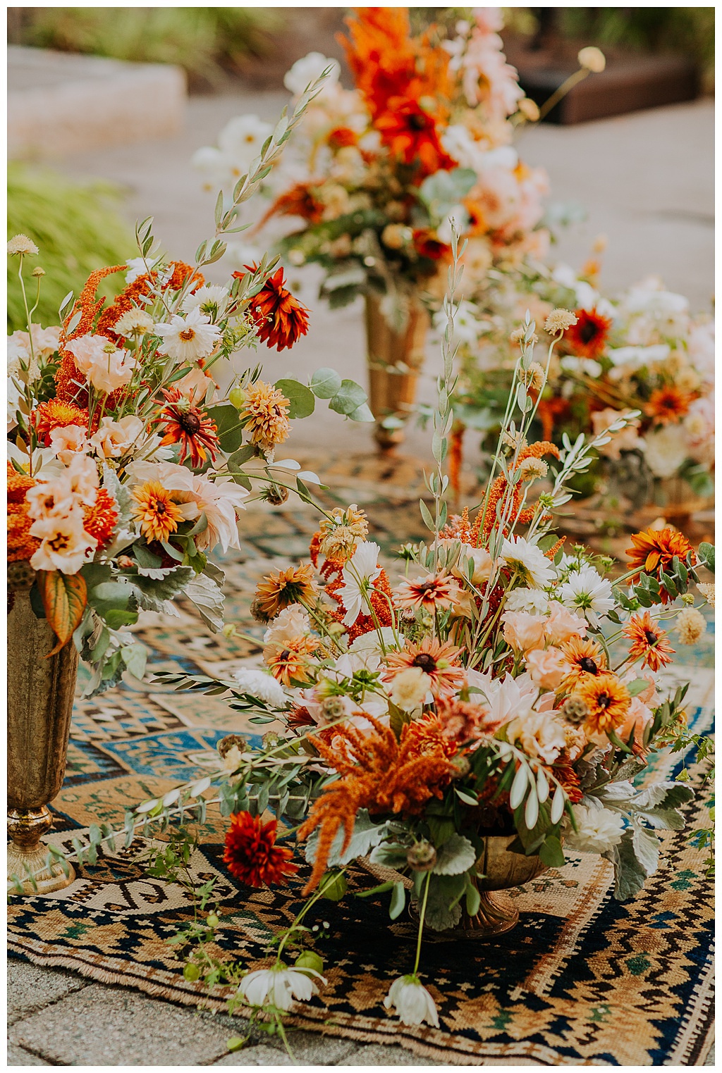The ceremony setup with lush fall wedding florals
