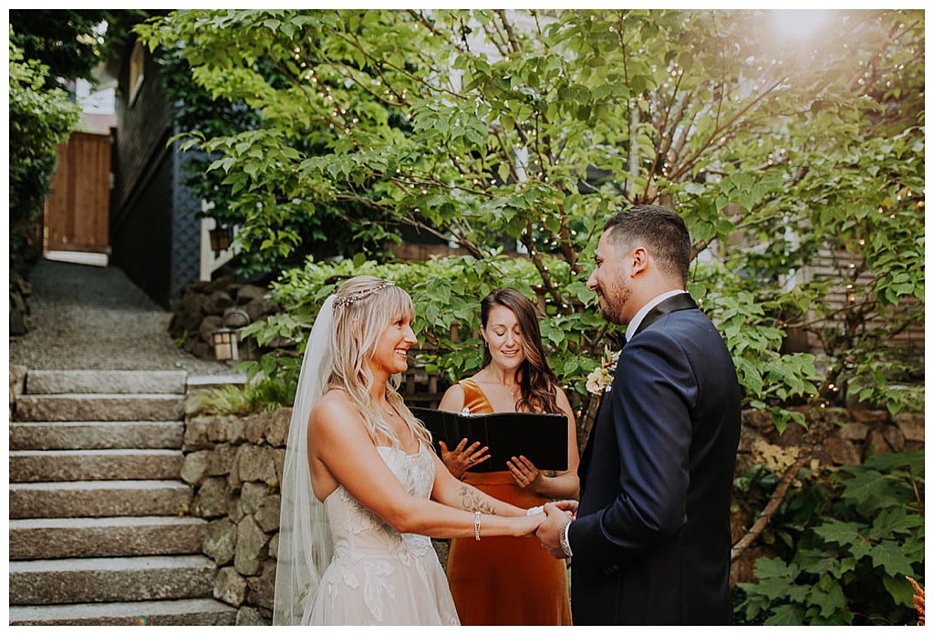 A couple stands and recites their vows during their small fall wedding ceremony