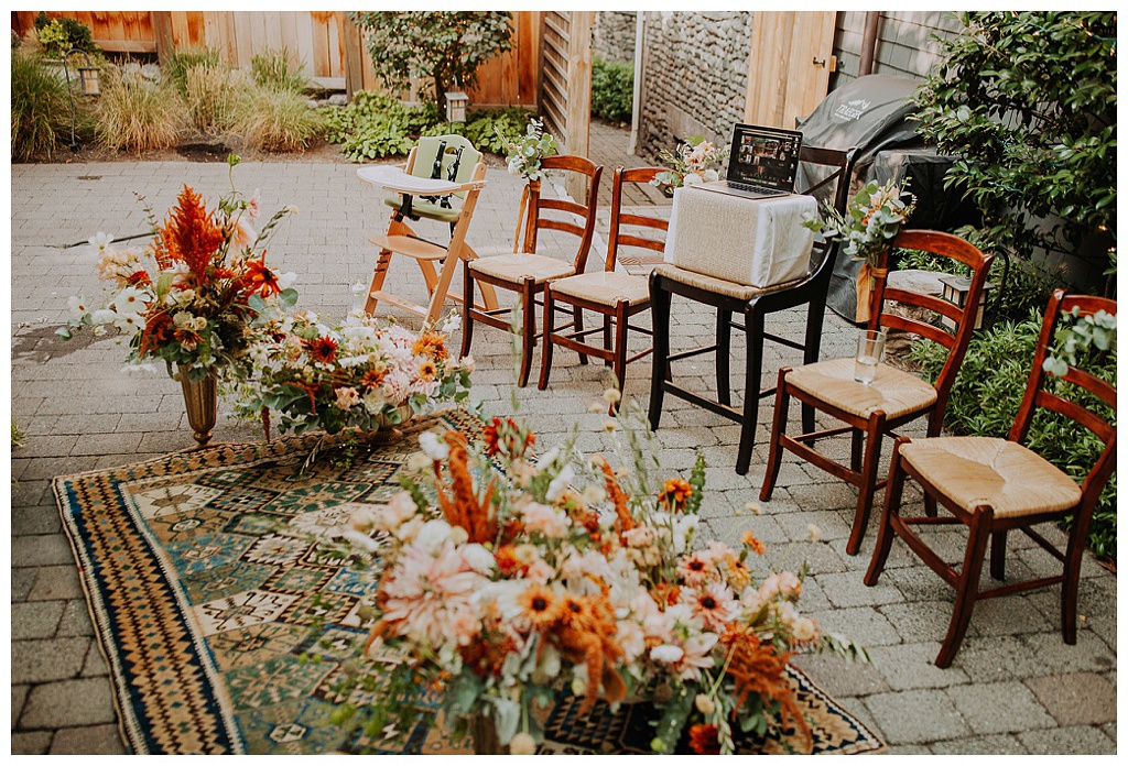An intimate, fall wedding setup with boho florals and carpet