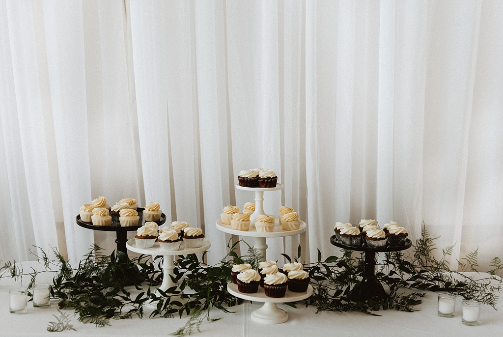 A dessert table with foliage and florals