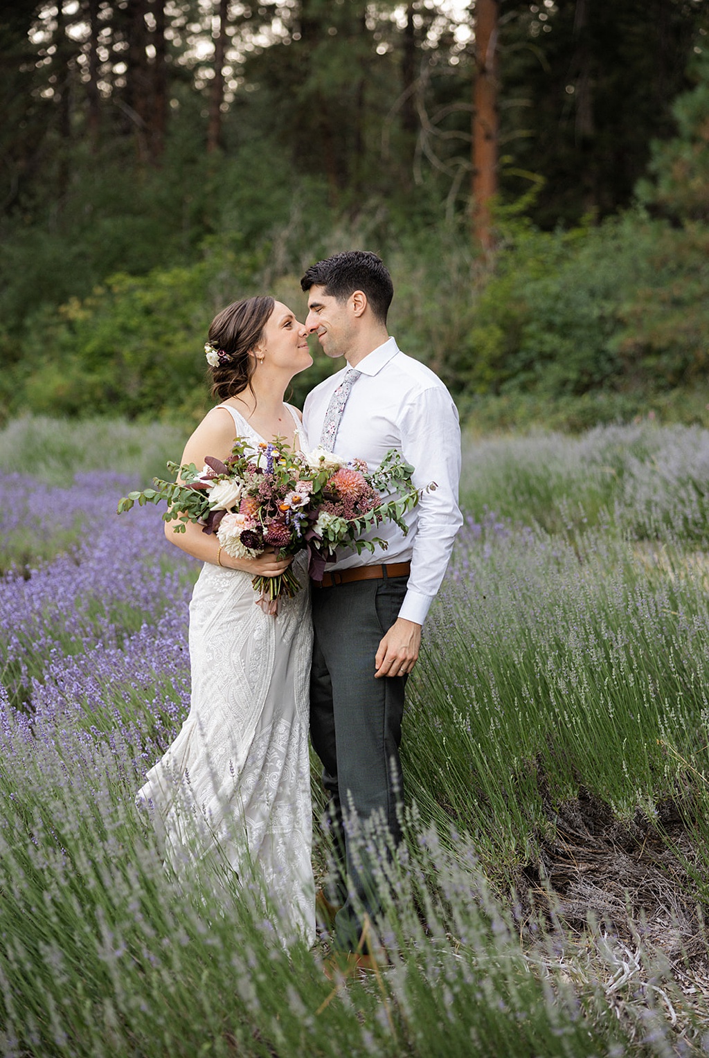 The couple stands in a lavender field at this Tierra Retreat Center wedding