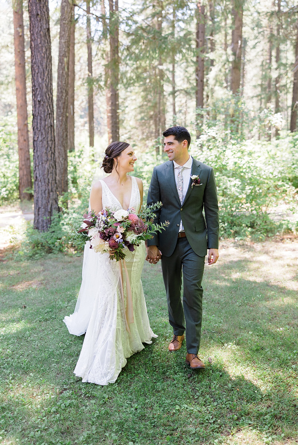 The bride and groom walk through the woods at this Tierra Retreat Center wedding