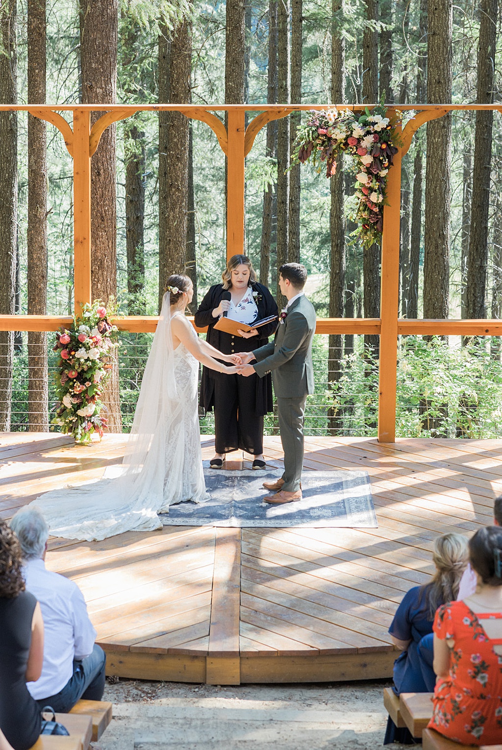 Wedding florals and wooden platform for the wedding ceremony at Tierra Retreat Center