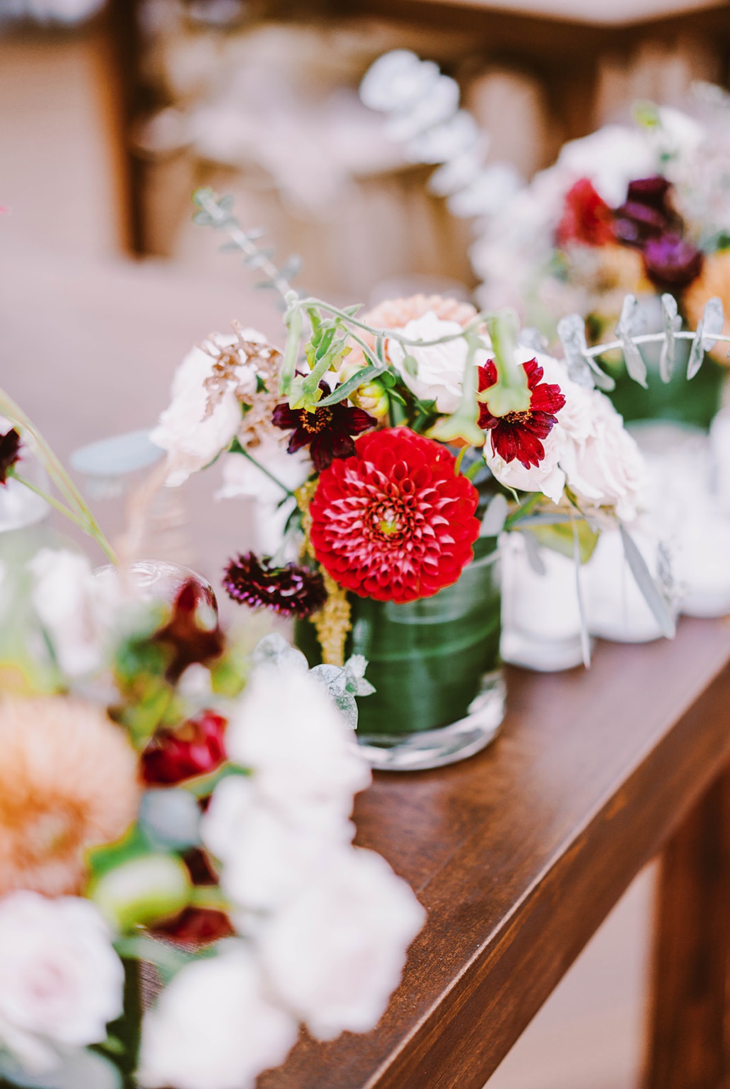 Pops of colorful dahlias for cocktail table flowers at this summer wedding