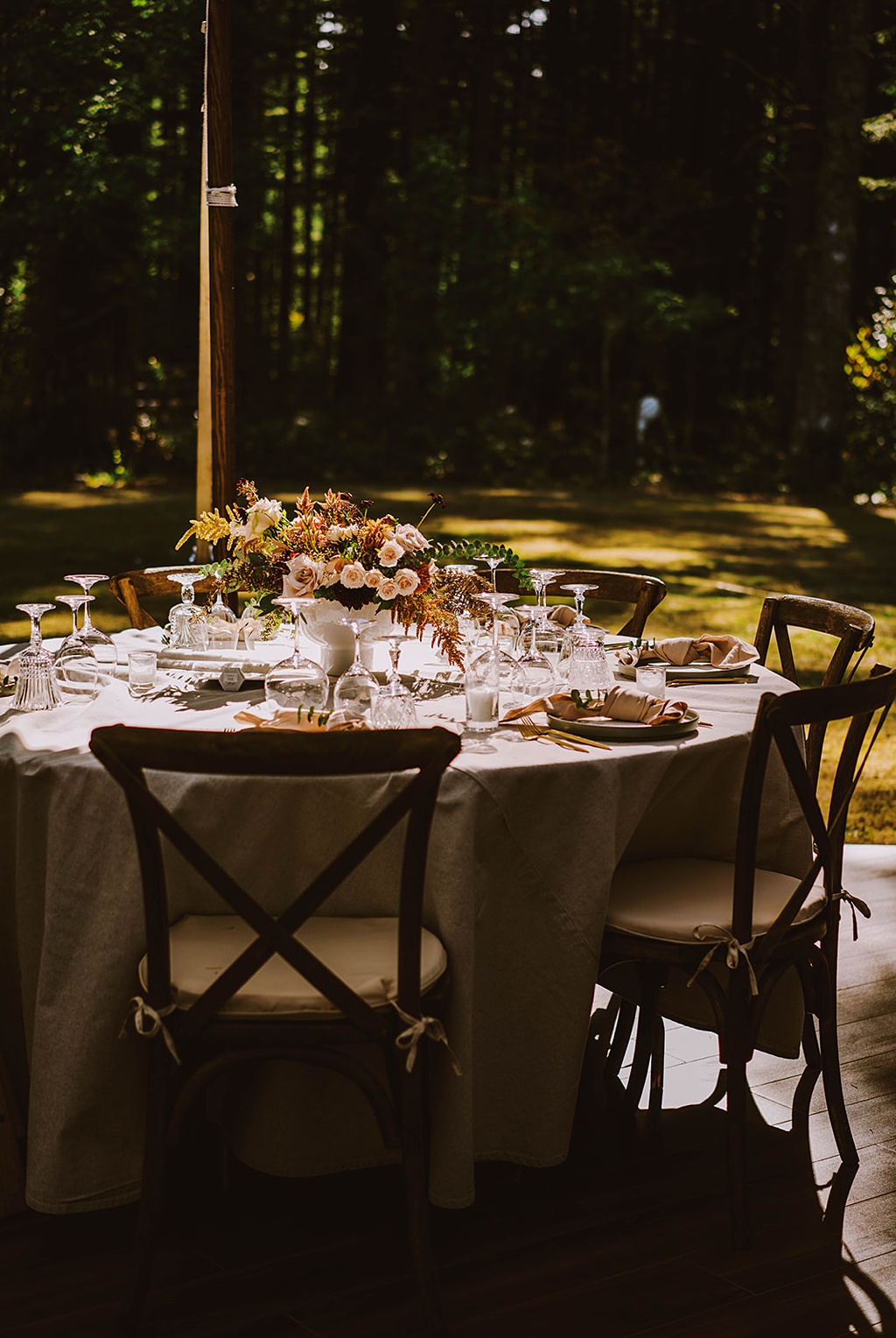 A moody shot of a summer wedding table in the sun and shade